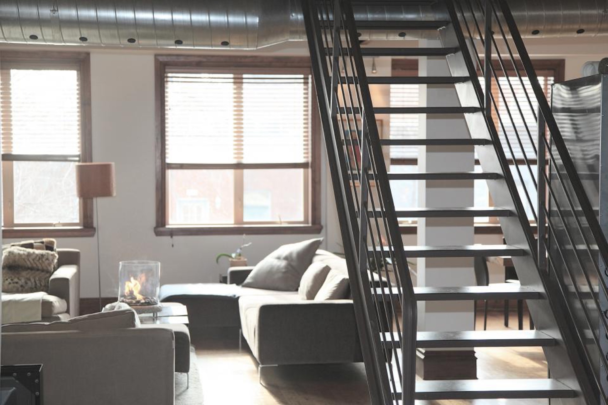Loft z metalowymi schodami i dużymi oknami